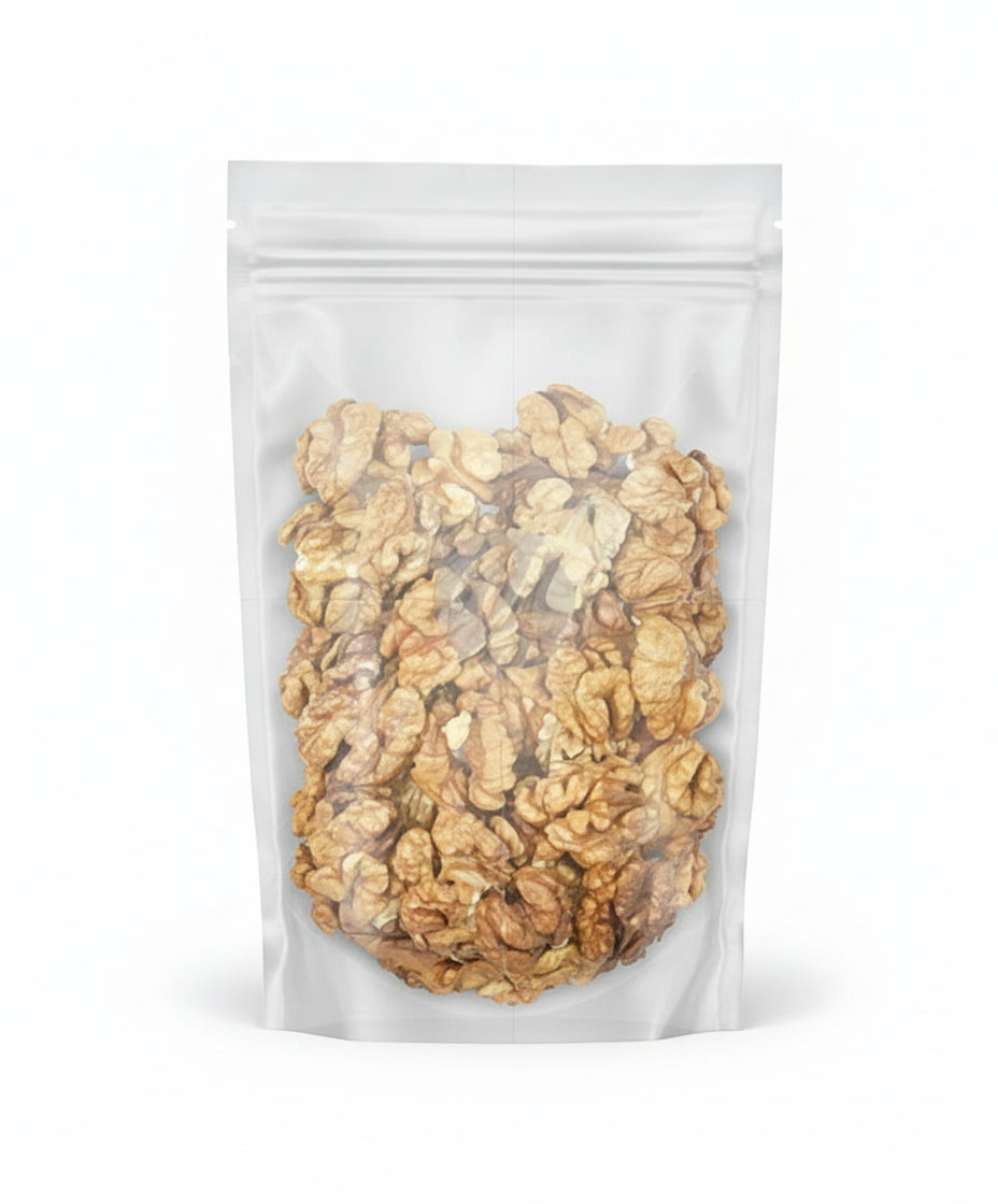 Clear plastic bag filled with walnuts on a white background