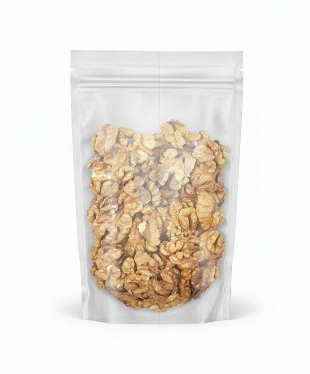 Clear plastic bag filled with walnuts on a white background